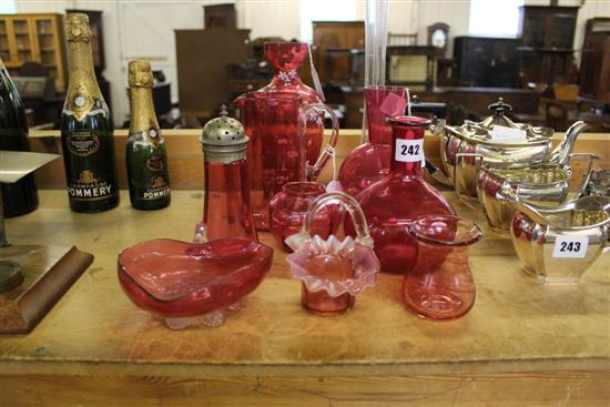 Ten items of cranberry glassware, inc a vase painted with flower heads